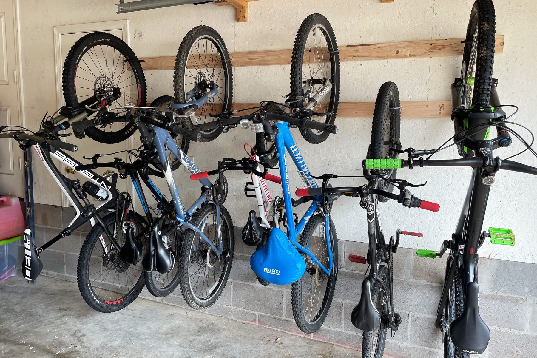 Mountain bikes hung on wall rails in the Camellia A garage