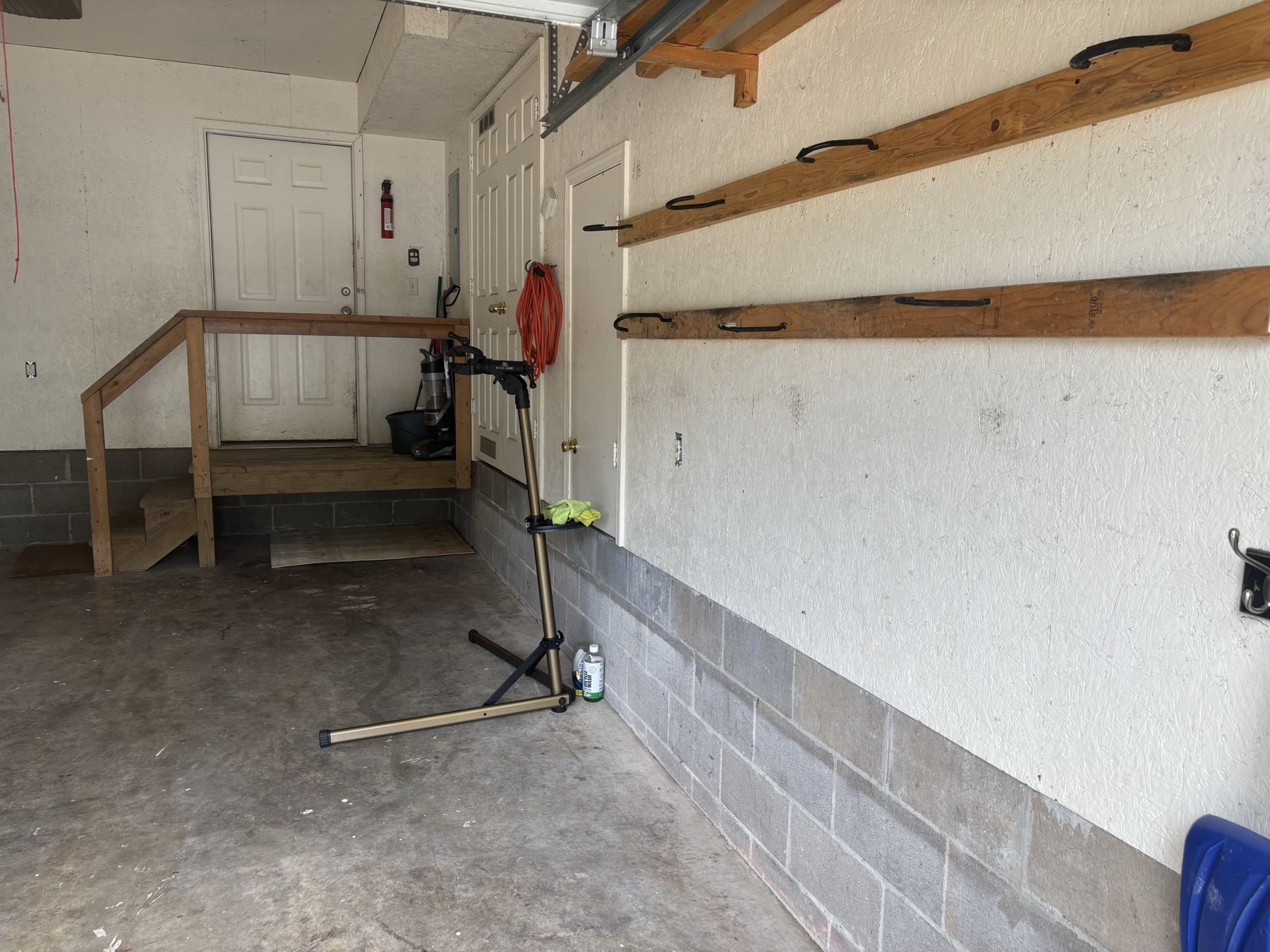 Camellia B garage with hanging bike rails and a repair stand